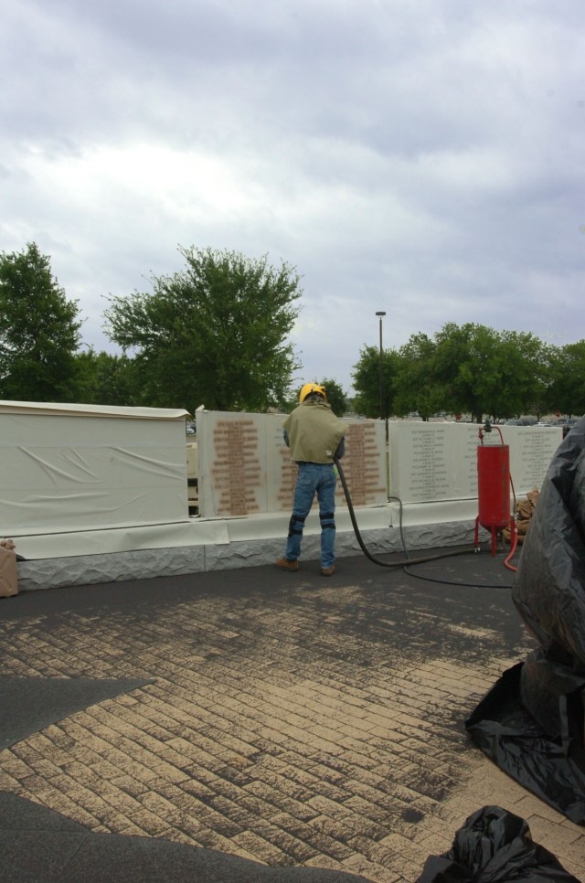 Wayne Smith with the Waco, Texas-based monument business Phipps Memorial adds names of fallen Soldiers who made the ultimate sacrifice during Operation Iraqi Freedom 06-08 at the 1st Cavalry Division's OIF memorial beside Fort Hood, Texas's Cooper...