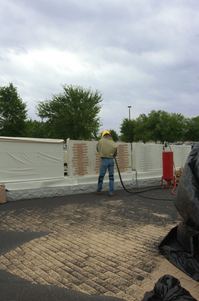 Wayne Smith with the Waco, Texas-based monument business Phipps Memorial adds names of fallen Soldiers who made the ultimate sacrifice during Operation Iraqi Freedom 06-08 at the 1st Cavalry Division's OIF memorial beside Fort Hood, Texas's Cooper Fi...