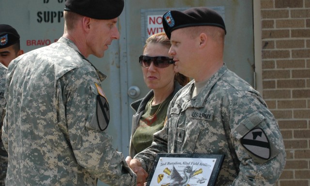 Col. Gary Valesky (left), commander of the 3rd Brigade Combat Team, 1st Cavalry Division, congratulates Sgt. Andrew Banyi, Battery B, 2nd Battalion, 82nd Field Artillery Regiment, for reenlisting at Fort Hood, Texas, April 16. The battalion was...