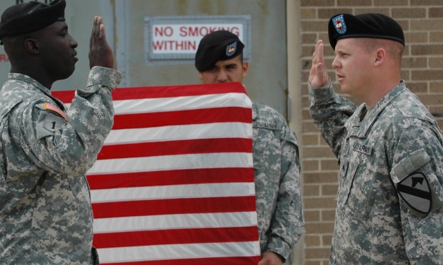 Sgt. Andrew Banyi (right) reenlists with the help of his battery commander, Capt. Derrick Borden, commander of Battery B, 2nd Battalion, 82nd Field Artillery Regiment, 3rd Brigade Combat Team, 1st Cavalry Division, at Fort Hood, Texas, April 16. The ...