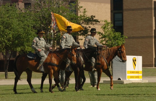 (Left to right) The 1st Cavalry Division's outgoing top noncommissioned officer Command Sgt. Maj. Philip F. Johndrow, the division's commanding general Brig. Gen. (P) Vincent K. Brooks and the incoming deputy commanding general for support Brig....