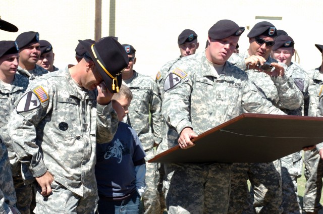 Soldiers of Dagger Troop, 1st Battalion, 82nd Field Artillery, 1st Brigade Combat Team, 1st Cavalry Division present Alma, Mich., native 1st Sgt. Richard Fisk, the top noncommissioned officer of Dagger Troop with a framed Dagger guidon engraved...