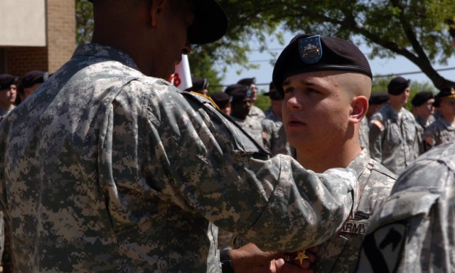 Spc. Steven Cornford, 3rd Battalion, 8th Cavalry Regiment, 3rd Brigade Combat Team, 1st Cavalry Division receives the Silver Star medal from Brig. Gen. (P) Vincent Brooks, division's commanding general, April 18. Cornford earned the award for excepti...