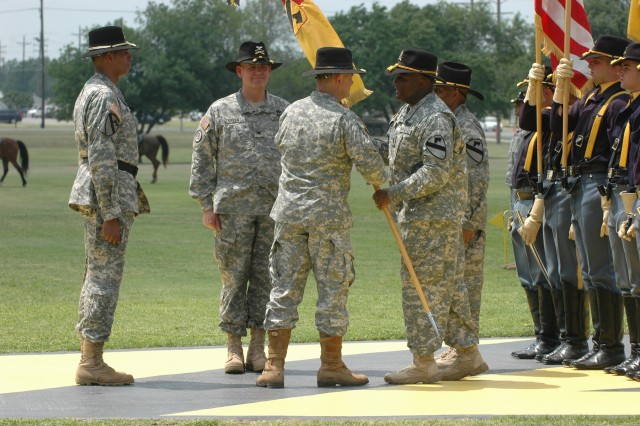 Just prior to Col. Paul E. Funk II, out-going commander, 1st "Ironhorse" Brigade Combat Team, 1st Cavalry Division, relinquishing command to Col. Tobin L. Green, the incoming Ironhorse Brigade commander, Funk (center) receives the Ironhorse...