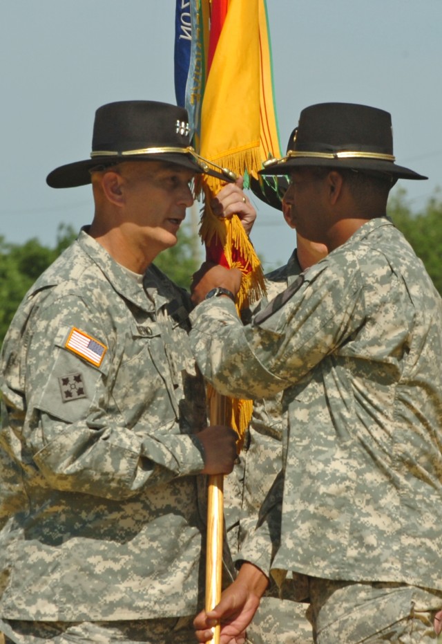 The outgoing commanding general of the 1st Cavalry Division, Brig. Gen. (P) Vincent K. Brooks of Alexandria, Va., passes the First Team's colors to Lt. Gen. Raymond T. Odierno, the commanding general of the U.S. Army's III Corps during the division's...