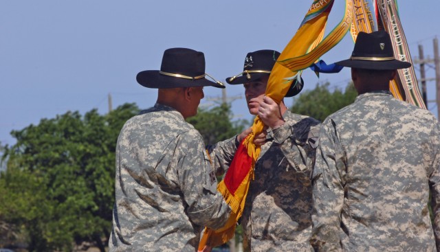 The new commanding general of the 1st Cavalry Division Maj. Gen. Daniel P. Bolger (center) of Aurora, Ill., accepts the First Team's colors of the from Lt. Gen. Raymond T. Odierno, the commanding general of III Corps who grew up in northern New...