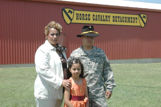 Maria Najera poses for a photo with her son, Paramount, Calif., native Spc. Rigoberto Saenz, a Bradley Fighting Vehicle mechanic for Company F, 2nd Battalion, 5th Cavalry Regiment, and his sister Ashley, after his re-enlistment ceremony April 30 at F...