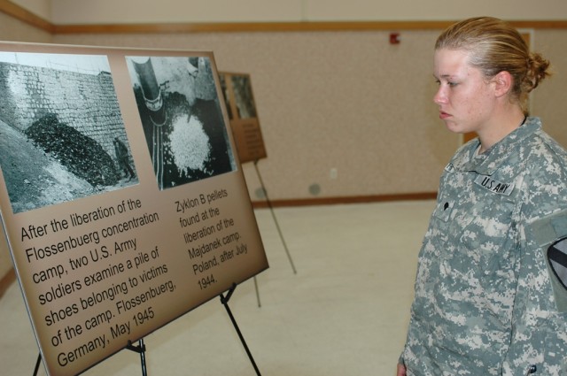 Birmingham, Ala., native Spc. Kristina Hunter, a fueler from 1st Battalion, 227th Aviation Regiment, 1st Air Cavalry Brigade, looks at a photo exhibit at the Days of Remembrance observance April 30 at Fort Hood, Texas. Hunter's great-great aunt...