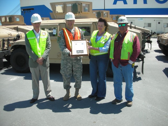 Team Leaders from the 841st Transportation Company accepts award from PM-LTV