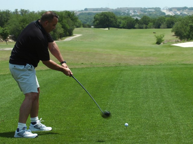 Command Sgt. Maj. Christopher Nadeau, the top enlisted Soldier from the 2nd Brigade Special Troops Battalion, 2nd Brigade Combat Team, 1st Cavalry Division, drives the ball down one of the fairways at the Clear Creek Golf Course during the Black...