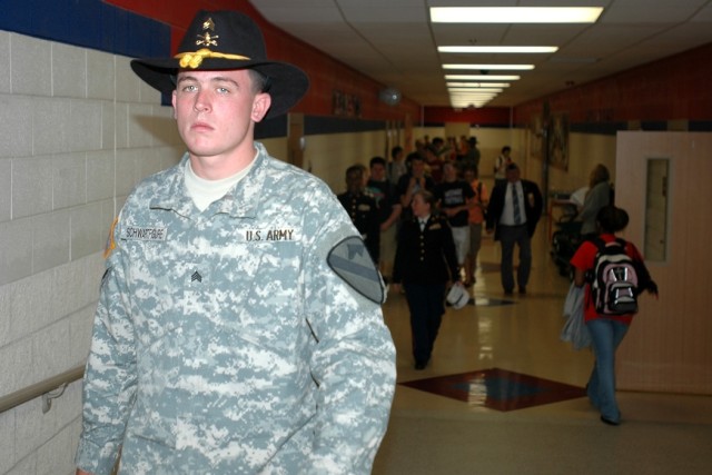 Cleveland, Ohio, native Sgt. Sean Schwartfigure, a mechanic for 615th Aviation Support "Cold Steel" Battalion, 1st Air Cavalry Brigade, 1st Cavalry Division, walks down a hall of Midway High School in Waco, Texas, during a visit May 9. Cold 
Steel vi...