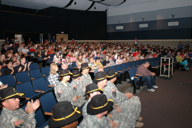 Soldiers from 615th Aviation Support "Cold Steel" Battalion, 1st Air Cavalry Brigade, 1st Cavalry Division, get ready to take the stage for students and faculty at Midway High School in Waco, Texas, during a ceremony May 9. The Midway Panthers sent h...