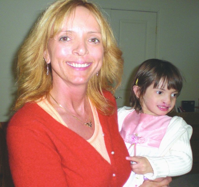 Karen Sellers-Myers holds her adopted daughter Sophia after surgery that began repairs to Sophia&#039;s cleft palate.