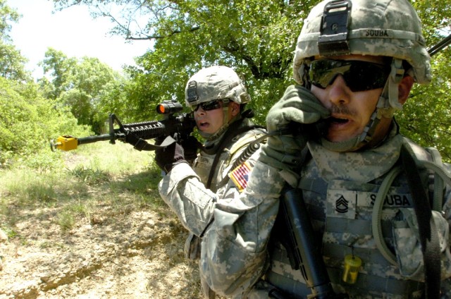 Colorado Springs, Colo., native Sgt. 1st Class Chris Souba and Long Beach Calif., native Pfc. Matt Turpin communicate with troops overhead from the 4th Battalion, 227th Aviation Regiment, while attacking a simulated enemy during a situational...