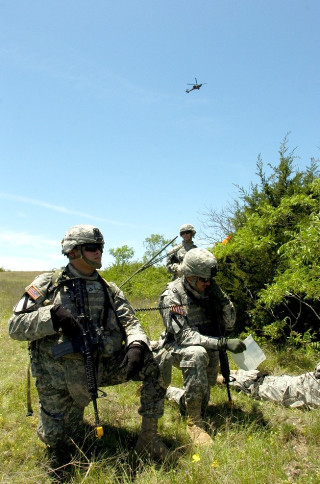 Yonkers, N.Y., native Staff Sgt. Anthony Cohen communicates with an AH-64 Apache helicopter while the rest of his squad from the White Platoon, Troop B, 4th Squadron, 9th Cavalry Regiment, 2nd Brigade Combat Team, 1st Cavalry Division, gets ready...