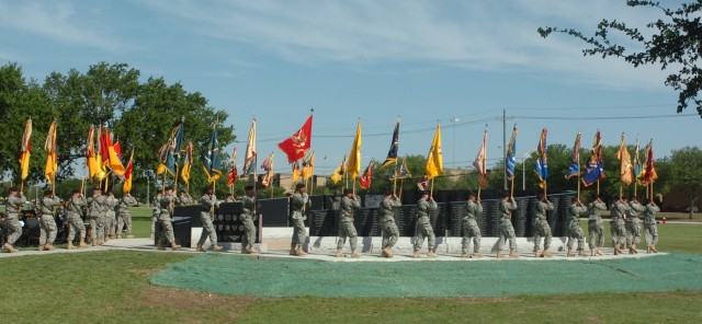 The unit colors of the 1st Cavalry Division make their way around the division's Operation Iraqi Freedom memorial to begin the rededication ceremony held at Cooper Field May 16. The memorial was rededicated after having 493 names added to the black-s...