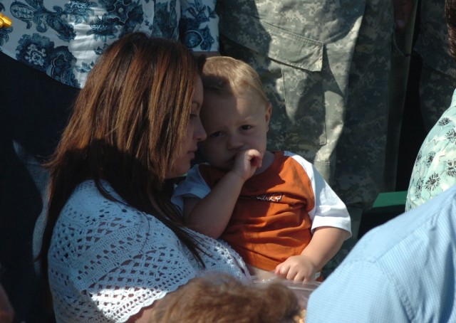 Burleson, Texas, native Stacey Markham holds her son Daniel tightly as the national anthem is played at the start of a rededication ceremony held at Cooper Field May 16. The 1st Cavalry Division's Operation Iraqi Freedom memorial was rededicated...