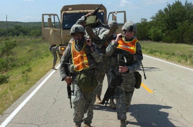 Pfc. Fernando Duarte (left) from Miami and Spc. Robert Pyle, a native of Columbus, Ohio, help carry one of their squad members during a training event conducted by Company B, 1st Battalion, 5th Cavalry Regiment, 2nd Brigade Combat Team, 1st...