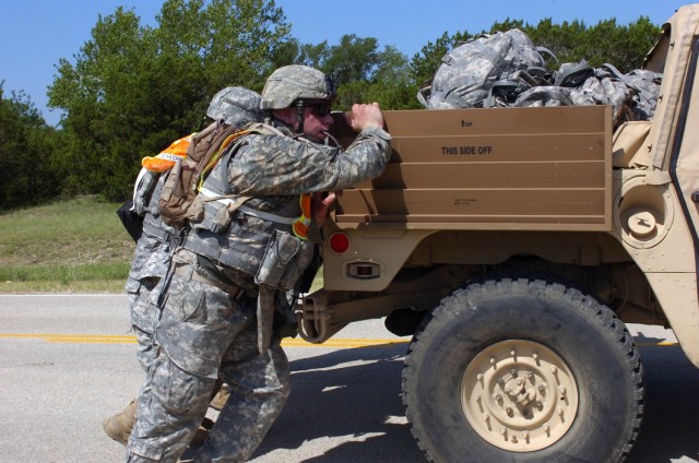 Pfc. William White of Forrest Grove, Ore., helps his squad push a humvee during The Bushmaster Squad PT Competition at North Fort Hood May 28. The competition was put on by Company B, 1st Battalion, 5th Cavalry Regiment, 2nd Brigade Combat Team,...