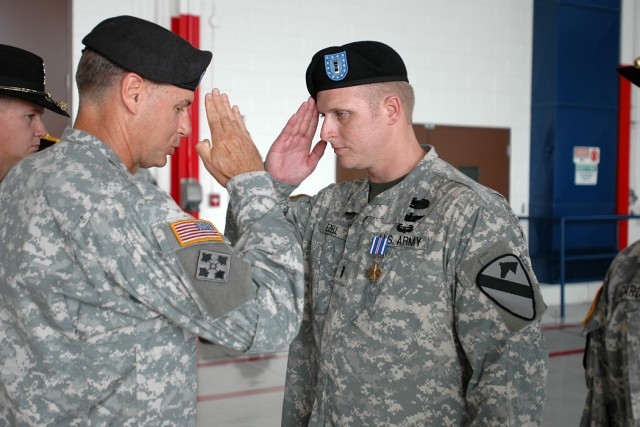Geneva, Ala. native Chief Warrant Officer 3 Christopher Ezell (right), an AH-64D Apache attack helicopter pilot for 4th Battalion, 227th Aviation Regiment, 1st Air Cavalry Brigade, 1st Cavalry Division, salutes Brig. Gen. Frederick Rudesheim (left), ...