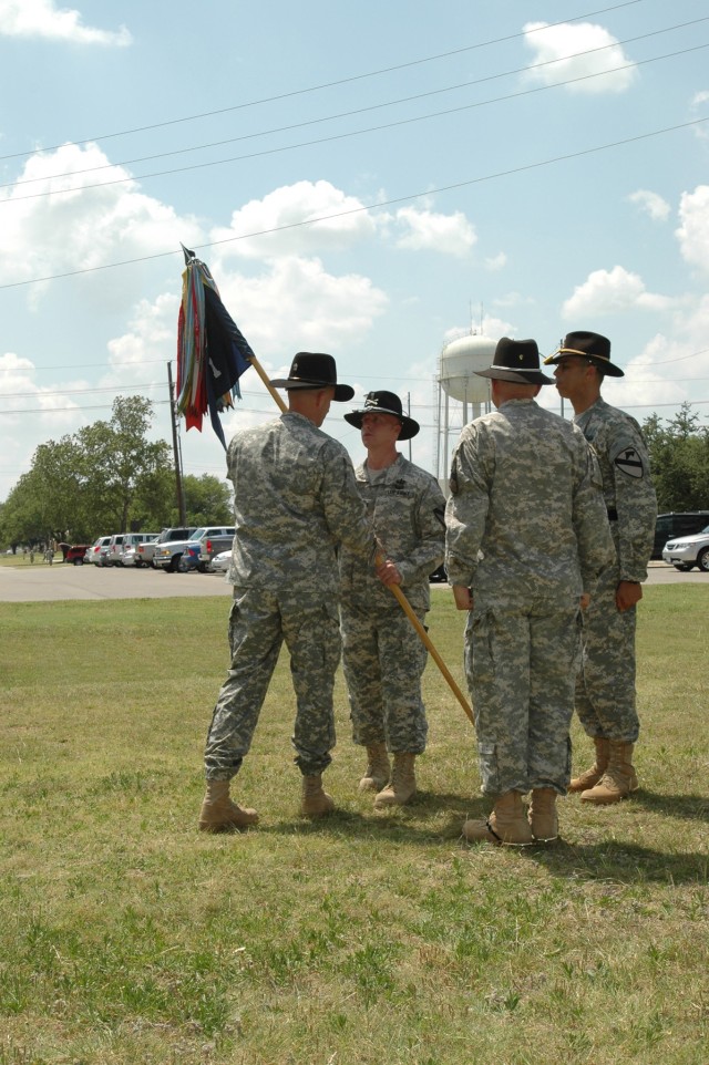 The Division Special Troops Battalion commander Lt. Col. Matthew G. Karres passes the band's colors to the band's incoming commander Chief Warrant Officer 4 Aaron Graff during a change of command ceremony held in front of the division's music hall...