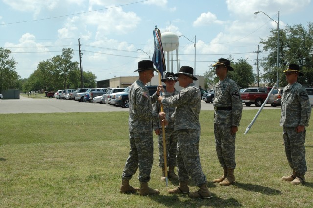 The 1st Cavalry Division band's outgoing commander Chief Warrant Officer 4 Glen Nardin passes the guidion to the Division Special Troops Battalion commander Lt. Col. Matthew G. Karres in a change of command ceremony held in front of the division's...