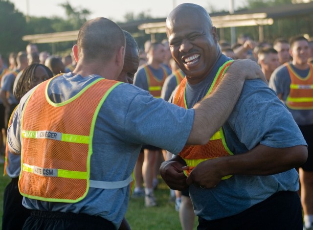 Command Sergeants Major Dennis Eger (left), Melvin Carr Jr. (obscured) and Brouston Hale enjoy a moment after the 4th Brigade Combat Team's last pre-deployment brigade run at Cooper Field May 30. The command sergeants major and their units should be ...