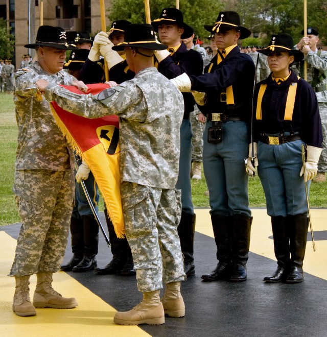 Col. Philip Battaglia (left) and Command Sgt. Maj. Edwin Rodriguez, the 4th "Long Knife" Brigade Combat Team, 1st Cavalry Division commander and top enlisted leader, case the brigade's colors during a casing ceremony at Fort Hood's Cooper Field...