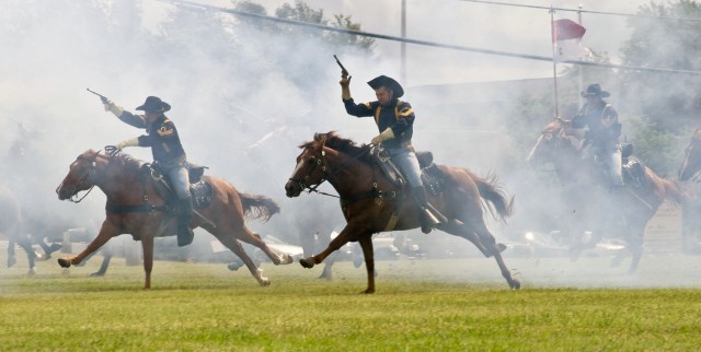 The 1st Cavalry Division's Horse Detachment charges across Cooper Field at Fort Hood, Texas following the 4th "Long Knife" Brigade Combat Team, 1st Cavalry Division color casing ceremony June 4. The Long Knife Brigade is scheduled to deploy to Iraq i...