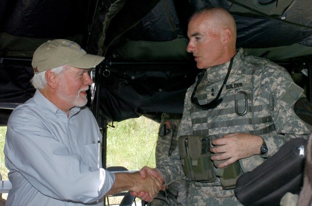 Nelson M. Ford (left), the acting under secretary of the Army and assistant secretary of the Army for Financial Management and Comptroller shakes hands with Aurora, Ill. native Maj. Gen. Daniel P. Bolger, commanding general, 1st Cavalry Division,...