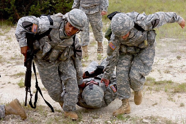 Spc. Derrick Horsley (left), originally from Lynchburg, Va. and Pvt. Robin Carr, a native of Meridian, Idaho drag a simulated casualty, Puerto Rico native, Spc. Cesar Velilla, to safety during combat lifesaver training conducted by 3rd Battalion,...