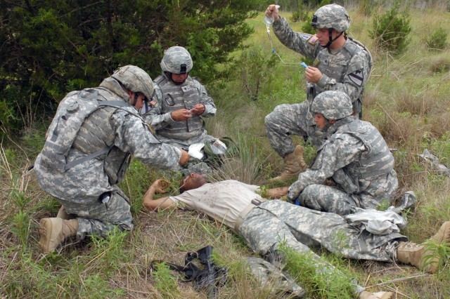 Soldiers from the 3rd Battalion, 82 Field Artillery Regiment, 2nd Brigade Combat Team,1st Cavalry Division attend to a simulated casualty during combat lifesaver training at Fort Hood, Texas June 5. Instead of the traditional classroom setting, these...