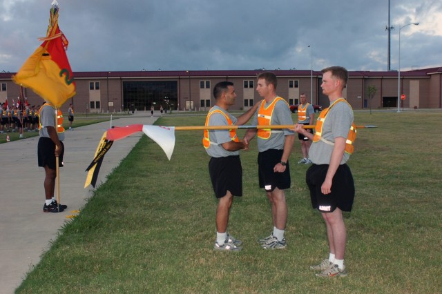 Capt. Brent Kinney, the commander of Company E, 1st Battalion, 5th Infantry Regiment, 2nd Brigade Combat Team, 1st Cavalry Division, is congratulated by Black Jack Brigade commander, Col. Ryan Gonsalves after receiving a retention streamer, June...