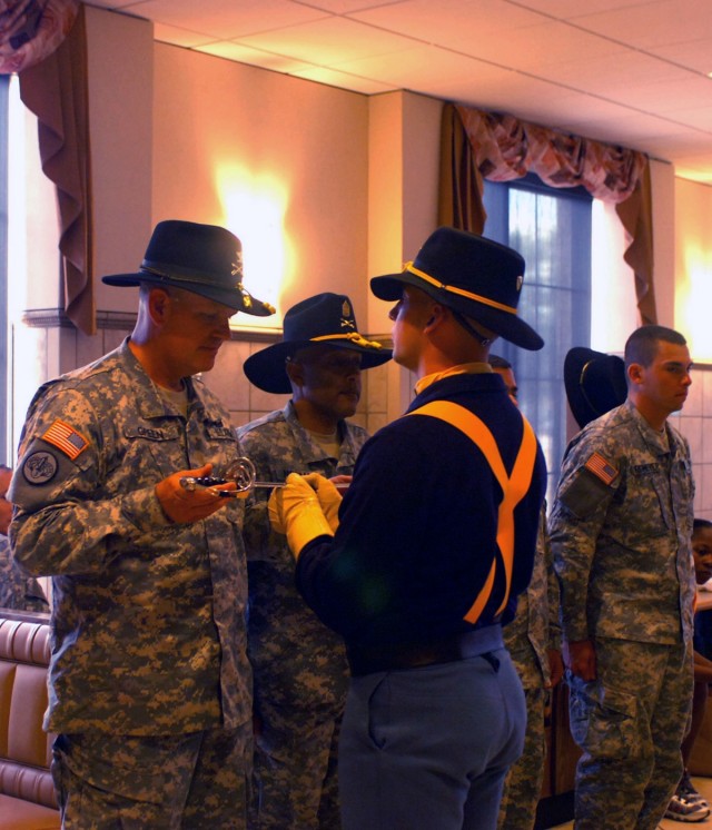 A member of the 1st Cavalry Division's Horse Cavalry Detachment presents Col. Tobin L. Green (left), brigade commander, 1st "Ironhorse" Brigade Combat Team, 1st Cav. Div., who hails from Sioux Falls, S. D., with a saber for the cutting of the...