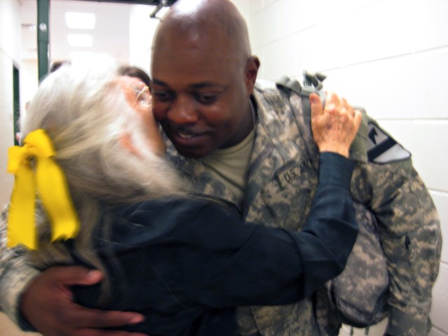 Chief Warrant Officer 3 Mickael Tatum, a targeting officer for the 1st Cavalry Division's 4th Brigade Combat Team and a native of Corpus Christi, Texas hugs Elizabeth Laird, Fort Hood's hug lady, at Robert Gray Army Airfield June 10.  Laird hugs...