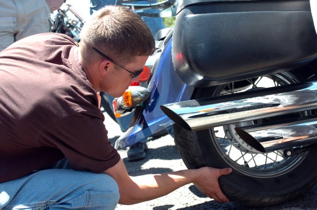 San Angelo, Texas native Sgt. Michael Middleton (left), shop foreman for Troop D, 1st Squadron, 7th Cavalry Regiment plugs a tire and checks the pressure before continuing on the ride back from Llano, Texas during the Ironhorse Bike Stampede June...