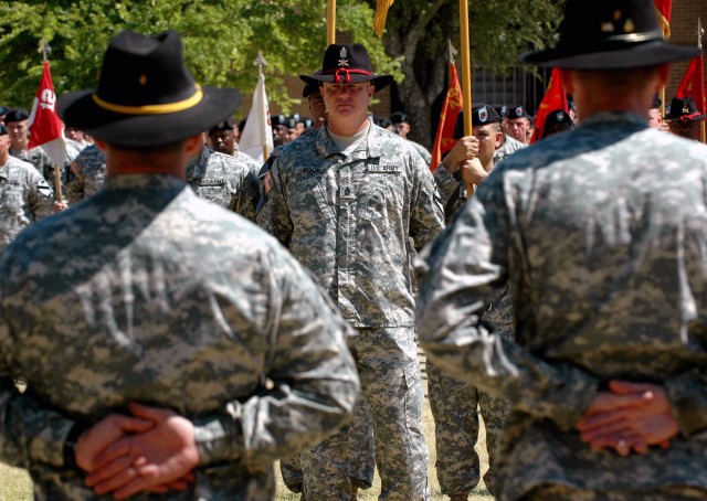 Command Sgt. Maj. Thomas Boon (center), of 2nd Battalion, 82nd Field Artillery Regiment, 3rd Brigade Combat Team, 1st Cavalry Division from San Antonio, Texas prepares to perform the passing of the unit's colors as part of a change of responsibility ...