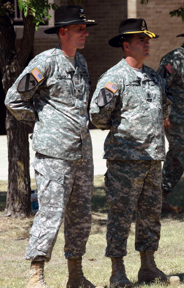 Col. Gary Volesky (left), commander of 3rd Brigade Combat Team, 1st Cavalry Division from Spokane, Wash., and the brigade's new command sergeant major, Archer City, Texas native Command Sgt. Maj. James Pippin from Archer City, Texas, wait to perform ...