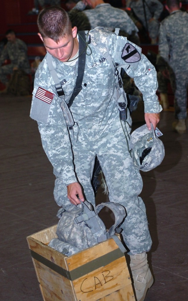 Titusville, Fla. native Spc. Corey Maier, a tanker with Troop D, 2nd Squadron, 7th Cavalry Regiment, checks to make sure his bag meets the space requirements for a flight to Kuwait. Along with Maier, nearly 60 other Soldiers from the 4th Brigade Comb...