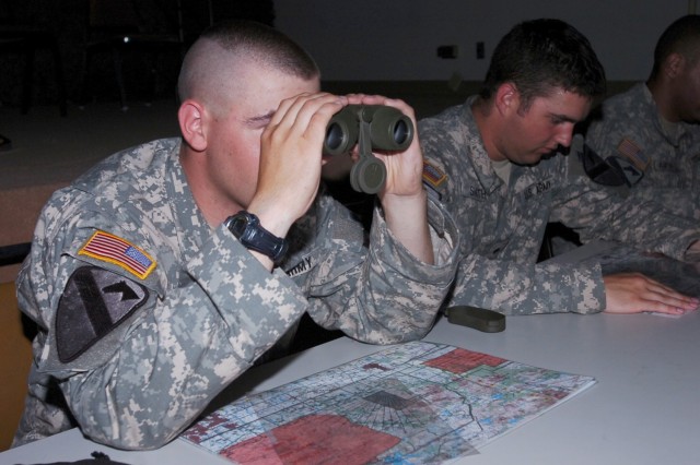 Staff Sgt. Travis Morrow, originally from Sauccentre, Minn. and assigned to 1st Battalion, 8th Cavalry Regiment, 2nd Brigade Combat Team, 1st Cavalry Division,  looks through binoculars while simulating a call for fire mission during the brigade's fi...