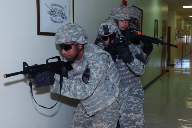 Sgt Brandon Ampofo, a native of Ft. Worth, Texas who is assigned to 1st Battalion, 8th Cavalry Regiment, 2nd Brigade Combat Team, 1st Cavalry Division, prepares to lead a team of fisters during room-clearing training, which was part of the...