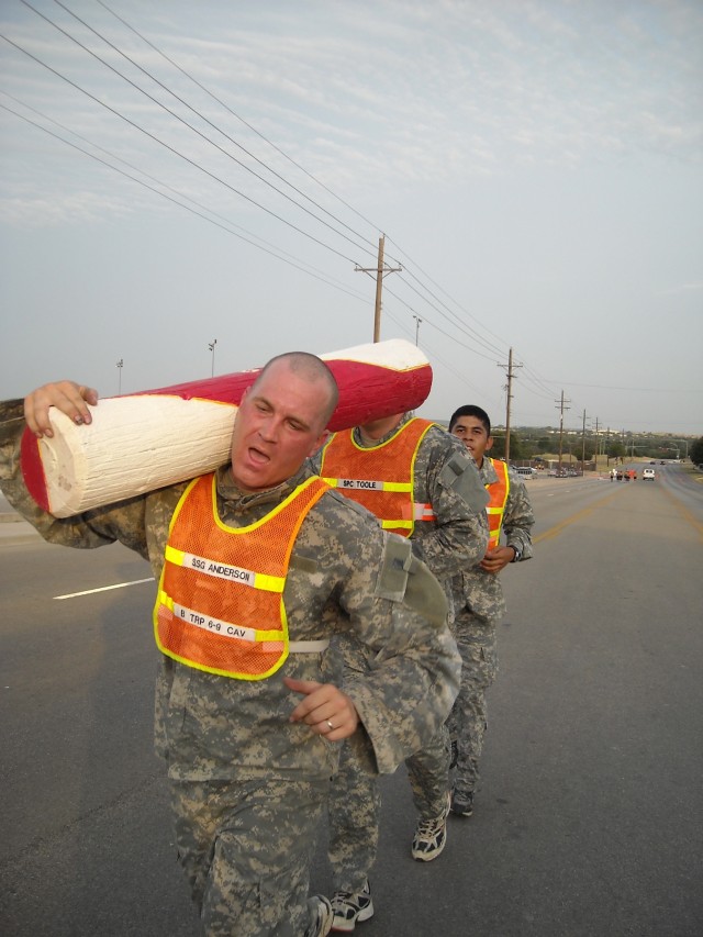 In his Army combat uniform, Floodwood, Minn. native Staff Sgt. Charles Anderson, a section sergeant in Troop B, 6th Squadron, 9th Cavalry Regiment runs with a log for four miles as part of a rigorous physical fitness routine recently implemented...