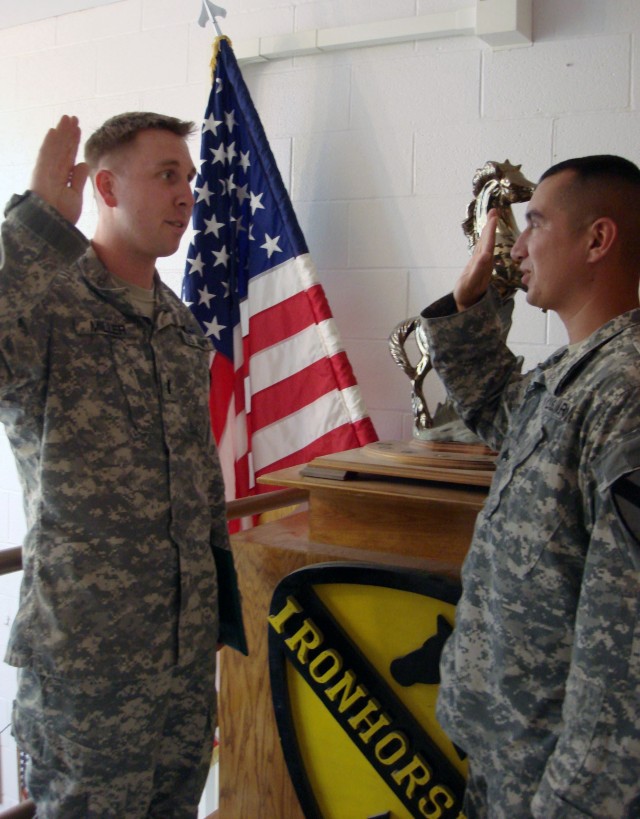 El Paso, Texas native Sgt. Hamurabi Torres (right), a petroleum supply specialist for Company A, 115th Brigade Support Battalion of the 1st Brigade Combat Team, 1st Cavalry Division takes the oath of enlistment given by his former platoon leader,...