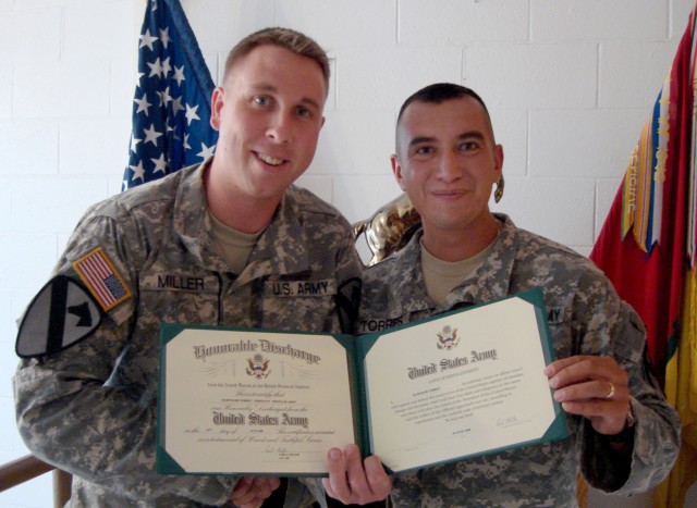 Immediately following his reenlistment and showing off his reenlistment certificate, El Paso, Texas native Sgt. Hamurabi Torres (right), a petroleum supply specialist with Company A, 115th Brigade Support Battalion, 1st Brigade Combat Team, 1st...