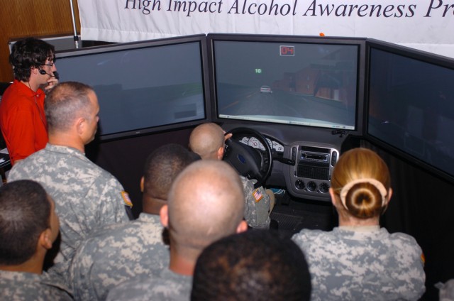 Soldiers from the Division Special Troops Battalion, 1st Cavalry Division wait in line to get their opportunity to drive a drunk driving simulator June 27 at Fort Hood, Texas during the 'Save A Life Tour,' a program that informs the public about...