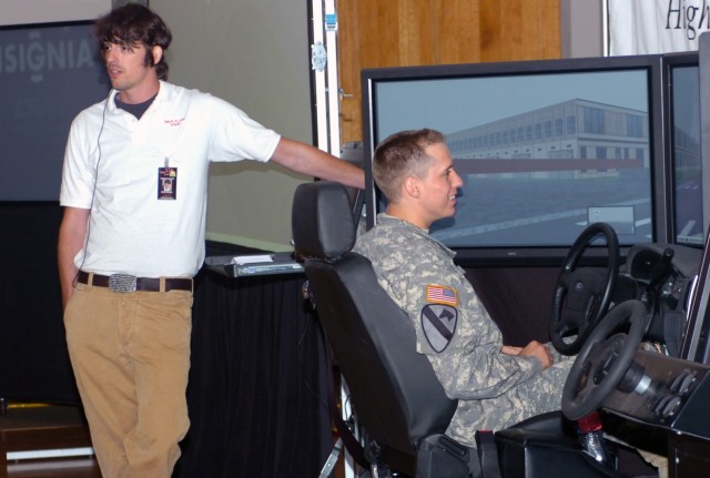 Brian Beldyga (left), tour manager and event facilitator for the 'Save A Life Tour' addresses an audience about the way the program's multi-million dollar drunk driving simulator mimics the effects of impaired driving while Scotsdale, Ariz. native Sp...