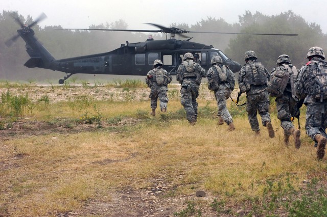 Cavalry scouts from Troop B, 4th Squadron, 9th Cavalry Regiment, 2nd Brigade Combat Team, 1st Cavalry Division, prepare to board a UH-60 Black Hawk helicopter from 3rd Battalion, 227th Aviation Regiment, 1st Air Cavalry Brigade, 1st Cav. Div., after ...