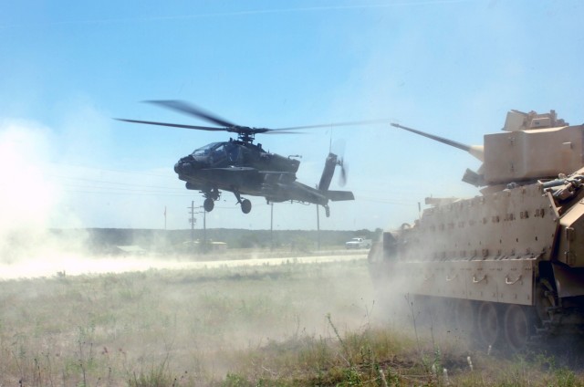 Colonel Gary Volesky, commander of the 3rd "Grey Wolf" Brigade Combat Team, 1st Cavalry Division, who hails from Spokane, Wash., takes off in the front seat of an AH-64D Apache attack helicopter with the help of Copperas Cove, Texas, native Chief...