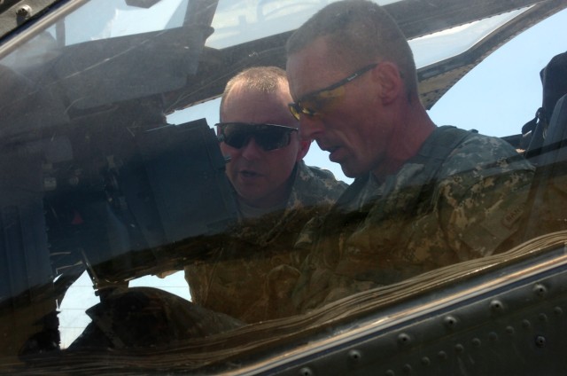 Colonel Douglas Gabram (left), commander of the 1st Air Cavalry "Warrior" Brigade, 1st Cavalry Division, who hails from Cleveland, goes over a quick refresher course on the AH-64D Apache attack helicopter with Spokane, Wash., native Col. Gary...
