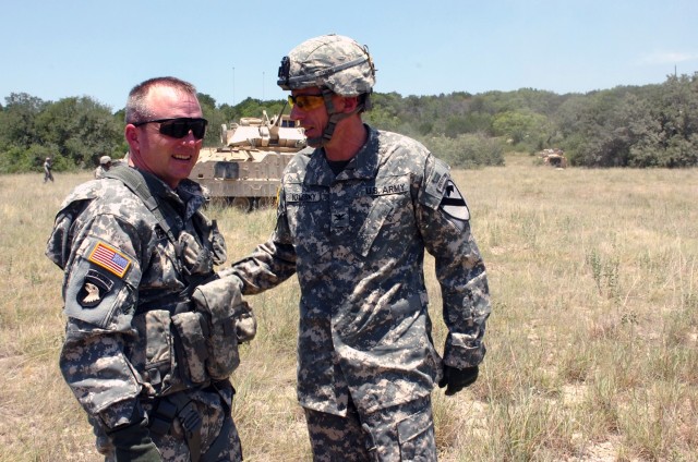 Colonel Douglas Gabram (left), commander of the 1st Air Cavalry "Warrior" Brigade, 1st Cavalry Division, who hails from Cleveland, discusses operations with his counterpart, Spokane, Wash., native Col. Gary Volesky (right), commander of the 3rd...